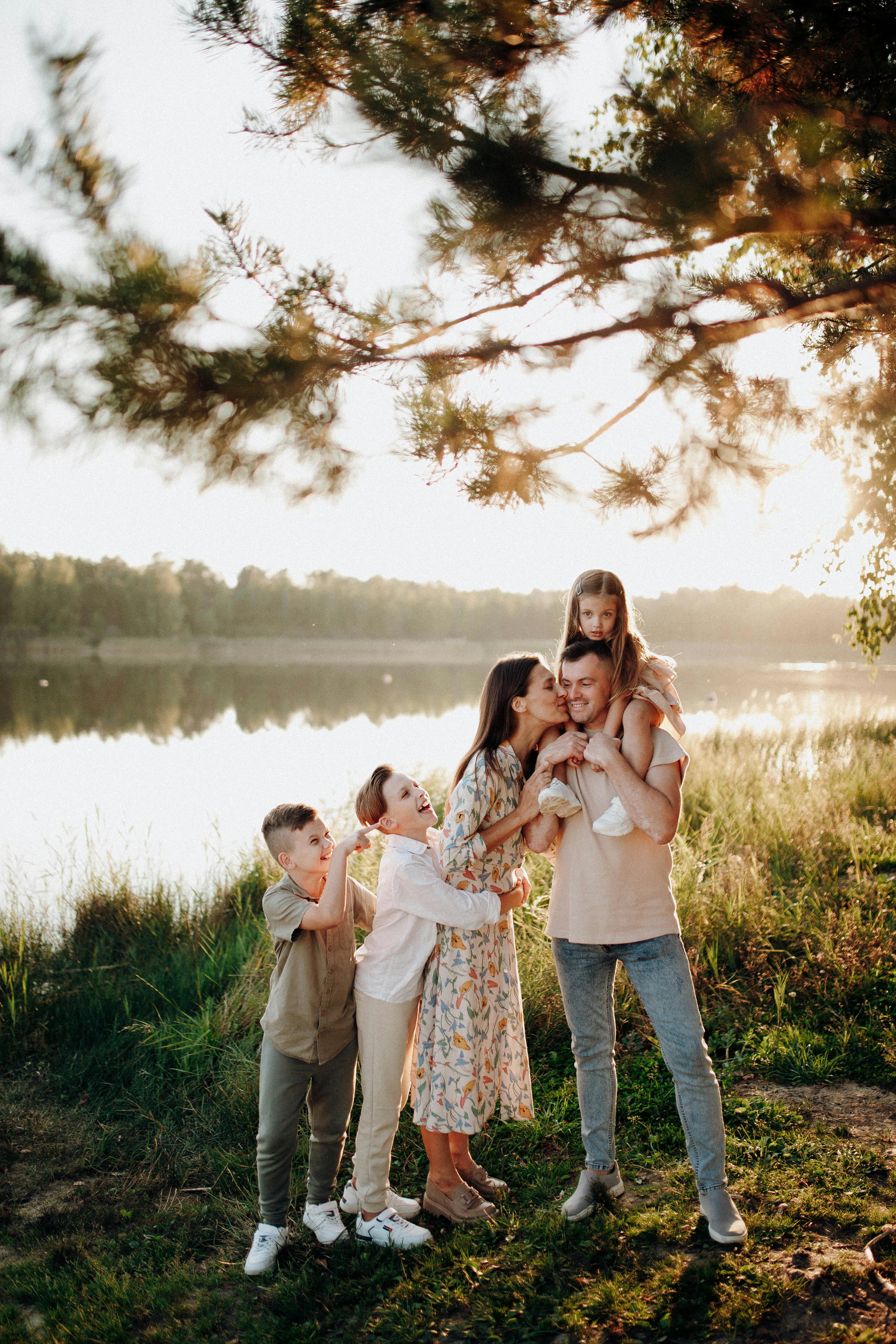 A happy family together by the lake at sunset